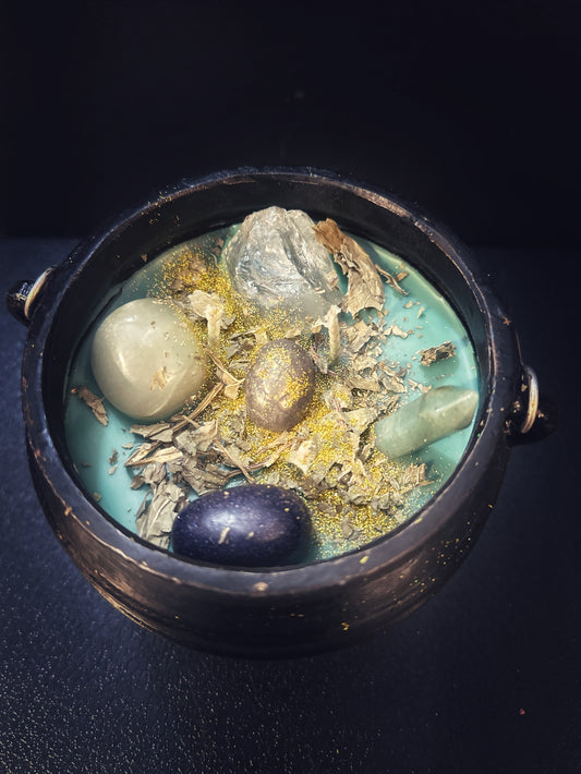 Green Fortuna Prosperity cauldron candle filled with herbs, crystals, and golden shimmer, hand-poured in cast iron for abundance rituals.